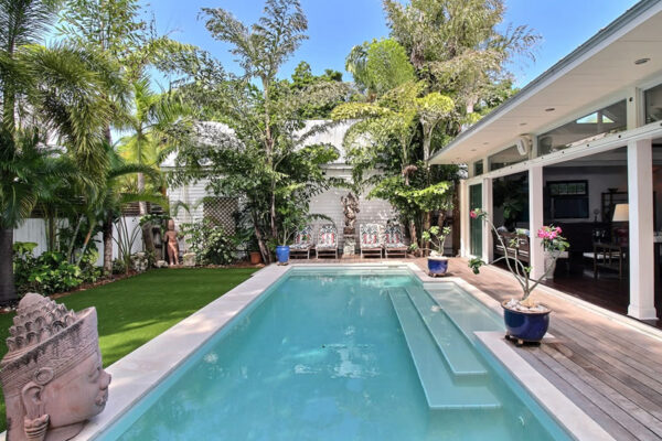 A picture of a beautiful back yard swimming pool and patio of a Key West, Florida home.